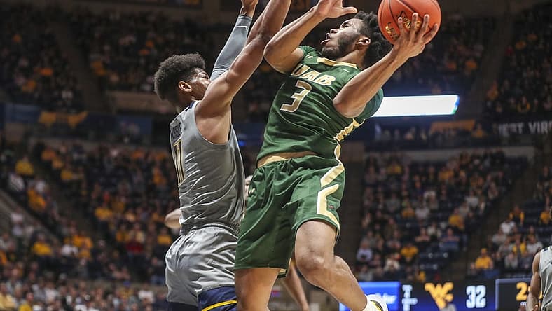 Dec 10, 2022; Morgantown, West Virginia, USA; UAB Blazers guard Tavin Lovan (3) shoots the ball against West Virginia Mountaineers forward Mohamed Wague (11) during the first half at WVU Coliseum. Mandatory Credit: Ben Queen-USA TODAY Sports