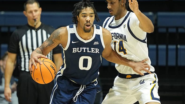 Dec 10, 2022; Berkeley, California, USA; Butler Bulldogs forward D.J. Hughes (0) dribbles against California Golden Bears forward Grant Newell (14) during the second half at Haas Pavilion. Mandatory Credit: Darren Yamashita-USA TODAY Sports