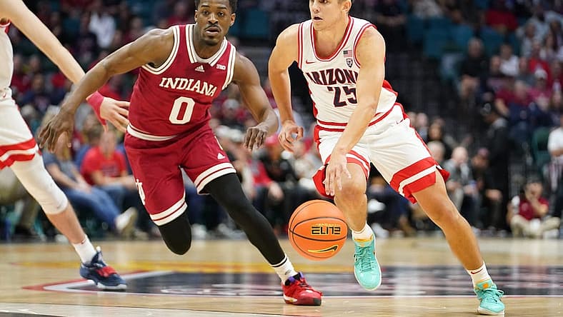 Dec 10, 2022; Las Vegas, Nevada, USA; Arizona Wildcats guard Kerr Kriisa (25) drives the ball against Indiana Hoosiers guard Xavier Johnson (0) during the first half at MGM Grand Garden Arena. Mandatory Credit: Lucas Peltier-USA TODAY Sports