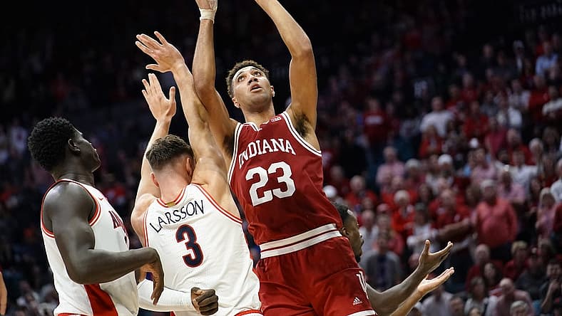 Dec 10, 2022; Las Vegas, Nevada, USA; Indiana Hoosiers forward Trayce Jackson-Davis (23) shoots the ball against Arizona Wildcats guard Pelle Larsson (3) and center Oumar Ballo (11) during the second half at MGM Grand Garden Arena. Mandatory Credit: Lucas Peltier-USA TODAY Sports