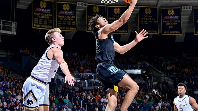 Dec 11, 2022; South Bend, Indiana, USA; Marquette Golden Eagles guard Stevie Mitchell (4) goes up for a shot as Notre Dame Fighting Irish guard Dane Goodwin (23) defends in the second half at the Purcell Pavilion. Mandatory Credit: Matt Cashore-USA TODAY Sports