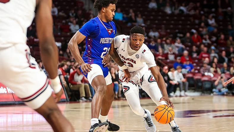 Dec 11, 2022; Columbia, South Carolina, USA; South Carolina Gamecocks forward Gregory Jackson II (23) drives around Presbyterian Blue Hose guard Trevon Reddish-Rhone (23) in the first half at Colonial Life Arena. Mandatory Credit: Jeff Blake-USA TODAY Sports