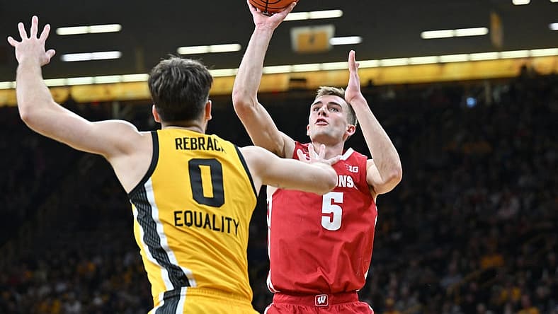 Dec 11, 2022; Iowa City, Iowa, USA; Wisconsin Badgers forward Tyler Wahl (5) shoots the ball over Iowa Hawkeyes forward Filip Rebraca (0) during the first half at Carver-Hawkeye Arena. Mandatory Credit: Jeffrey Becker-USA TODAY Sports