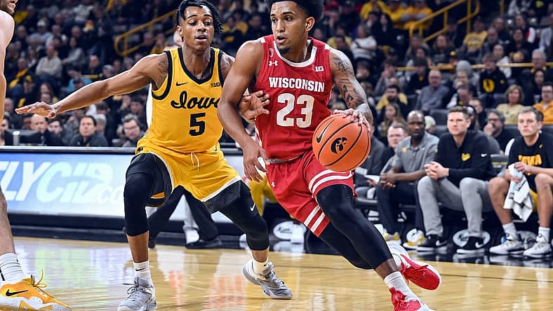Dec 11, 2022; Iowa City, Iowa, USA; Wisconsin Badgers guard Chucky Hepburn (23) goes to the basket as Iowa Hawkeyes guard Dasonte Bowen (5) defends during the first half at Carver-Hawkeye Arena. Mandatory Credit: Jeffrey Becker-USA TODAY Sports
