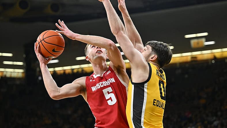 Dec 11, 2022; Iowa City, Iowa, USA; Wisconsin Badgers forward Tyler Wahl (5) shoots the ball as Iowa Hawkeyes forward Filip Rebraca (0) defends during the first half at Carver-Hawkeye Arena. Mandatory Credit: Jeffrey Becker-USA TODAY Sports