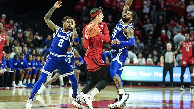 Dec 11, 2022; Piscataway, New Jersey, USA;  Rutgers Scarlet Knights guard Paul Mulcahy (4) tries to pass over Seton Hall Pirates guard Jamir Harris (15) in the first half at Jersey Mike's Arena. Mandatory Credit: Wendell Cruz-USA TODAY Sports