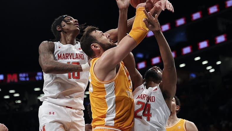Dec 11, 2022; Brooklyn, New York, USA; Tennessee Volunteers forward Uros Plavsic (33), Maryland Terrapins forward Julian Reese (10) and Maryland Terrapins forward Donta Scott (24) fight for the ball during the first half of a game at Barclays Center. Mandatory Credit: Jessica Alcheh-USA TODAY Sports