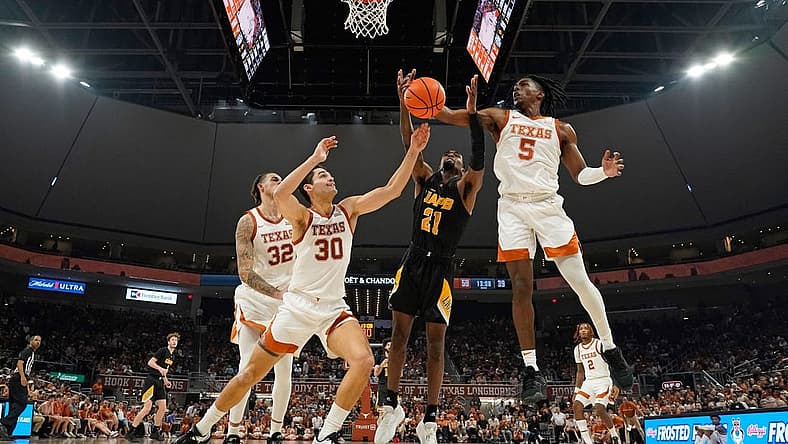 Dec 10, 2022; Austin, Texas, USA; Texas Longhorns guard Marcus Carr (5) and forward Brock Cunningham (30) along with Arkansas Pine-Bluff Golden Lions guard Shaun Doss Jr. (21) reach for a rebound during the second half at Moody Center. Mandatory Credit: Scott Wachter-USA TODAY Sports