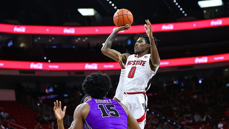 Dec 13, 2022; Raleigh, North Carolina, USA; North Carolina State Wolfpack guard Terquavion Smith (0) jumps above everyone to score a two pointer during the 1st half against Furman Paladins at PNC Arena. Mandatory Credit: Jaylynn Nash-USA TODAY Sports