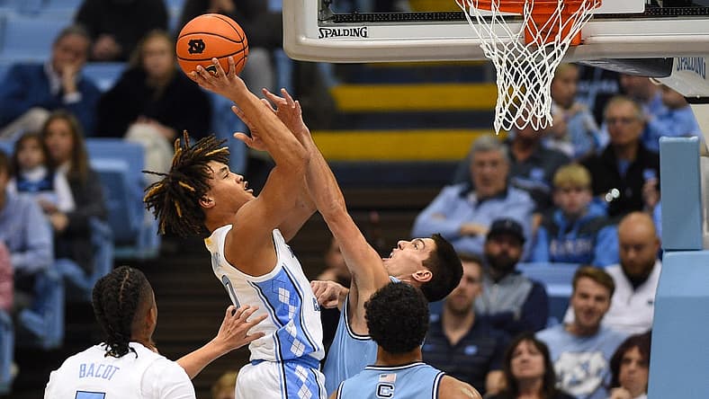 Dec 13, 2022; Chapel Hill, North Carolina, USA; North Carolina Tar Heels guard Seth Trimble (0) shoots as Citadel Bulldogs guard David Maynard (5) defends in the first half at Dean E. Smith Center. Mandatory Credit: Bob Donnan-USA TODAY Sports