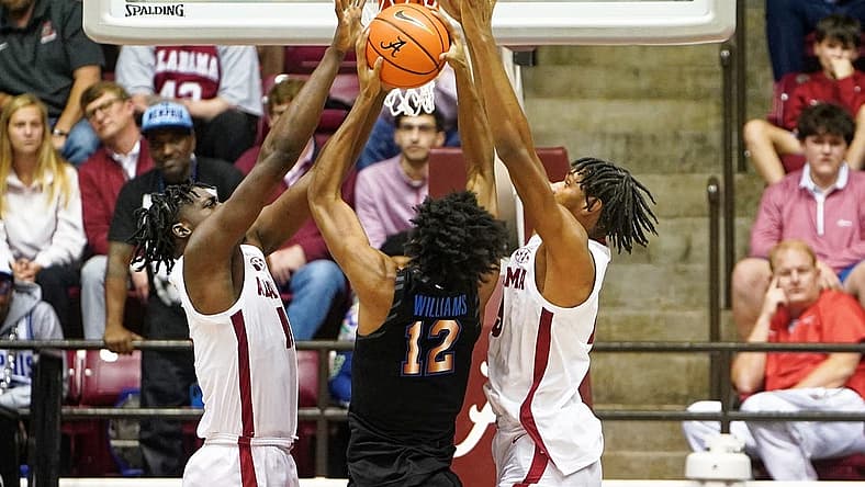 Dec 13, 2022; Tuscaloosa, Alabama, USA; Memphis Tigers forward DeAndre Williams (12) goes to the basket against Alabama Crimson Tide defenders during the second half at Coleman Coliseum. Mandatory Credit: Marvin Gentry-USA TODAY Sports