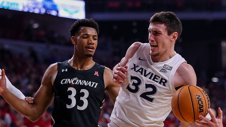 Dec 10, 2022; Cincinnati, Ohio, USA; Xavier Musketeers forward Zach Freemantle (32) against Cincinnati Bearcats forward Ody Oguama (33) in the first half at Fifth Third Arena. Mandatory Credit: Katie Stratman-USA TODAY Sports
