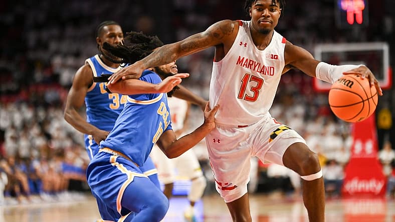 Dec 14, 2022; College Park, Maryland, USA; Maryland Terrapins guard Hakim Hart (13) dribbles by UCLA Bruins guard Tyger Campbell (10) during the second half at Xfinity Center. Mandatory Credit: Tommy Gilligan-USA TODAY Sports