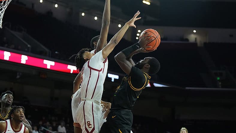 Dec 14, 2022; Los Angeles, California, USA; Long Beach State Beach guard Joel Murray (11) shoots against Southern California Trojans guard Boogie Ellis (5) and forward Joshua Morgan (24) in the first half at Galen Center. Mandatory Credit: Kirby Lee-USA TODAY Sports