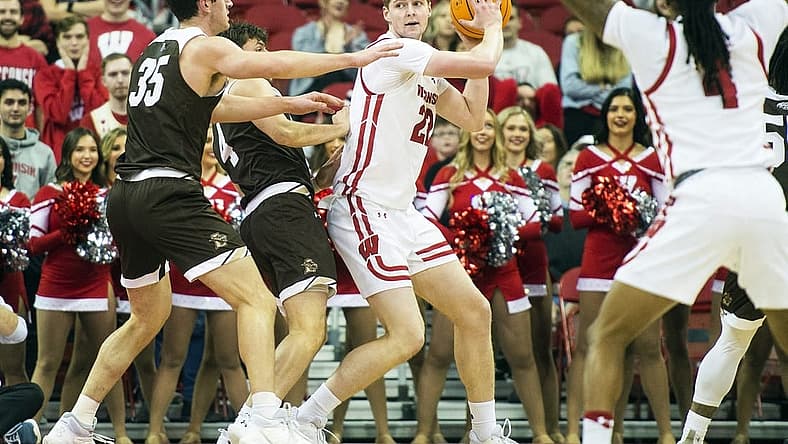 Dec 15, 2022; Madison, Wisconsin, USA; Wisconsin Badgers forward Steven Crowl (22) looks to pass the ball under coverage by Lehigh Mountain Hawks forward Dominic Parolin (35) and guard Reed Fenton (4) during the first half at the Kohl Center. Mandatory Credit: Kayla Wolf-USA TODAY Sports