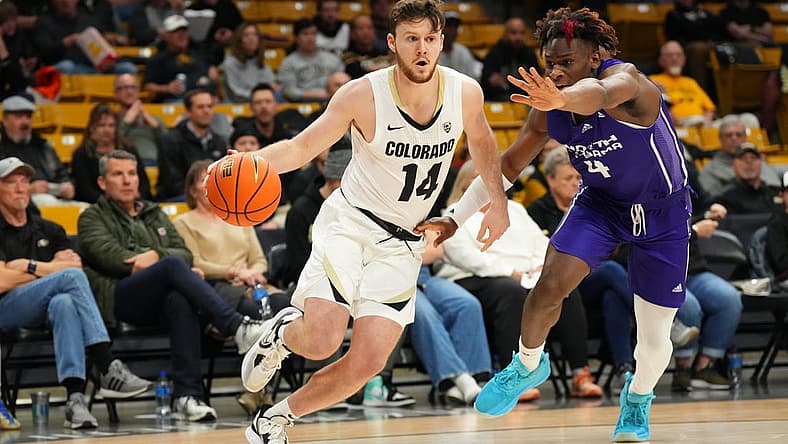 Dec 15, 2022; Boulder, Colorado, USA; Colorado Buffaloes guard Ethan Wright (14) drives past North Alabama Lions forward Bryson Dawkins (4) in the first half at the CU Events Center. Mandatory Credit: Ron Chenoy-USA TODAY Sports
