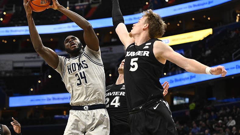 Dec 16, 2022; Washington, District of Columbia, USA; Georgetown Hoyas center Qudus Wahab (34) shoots over Xavier Musketeers guard Adam Kunkel (5) during the first half at Capital One Arena. Mandatory Credit: Brad Mills-USA TODAY Sports