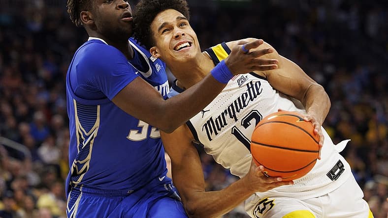 Dec 16, 2022; Milwaukee, Wisconsin, USA; Marquette Golden Eagles forward Oso Ighodaro (13) looks to shoot against Creighton Bluejays center Fredrick King (33) during the second half at Fiserv Forum. Mandatory Credit: Jeff Hanisch-USA TODAY Sports