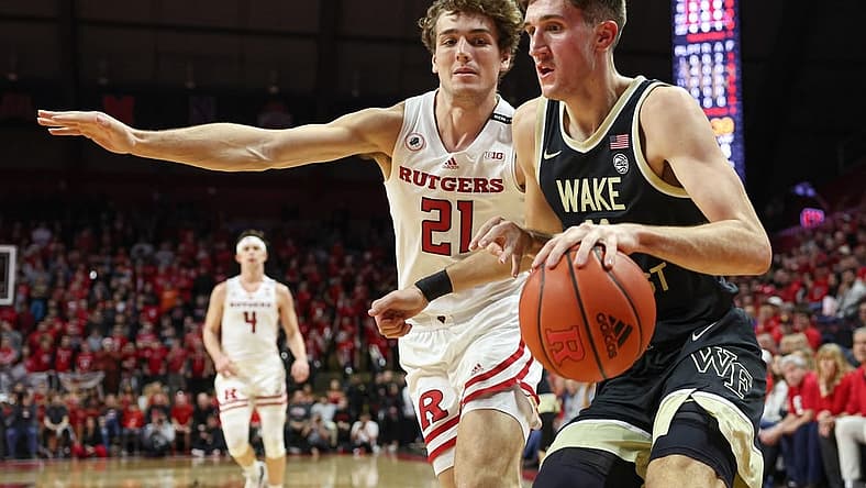 Dec 17, 2022; Piscataway, New Jersey, USA; Wake Forest Demon Deacons forward Andrew Carr (11) dribbles against Rutgers Scarlet Knights forward Dean Reiber (21) during the first half at Jersey Mike's Arena. Mandatory Credit: Vincent Carchietta-USA TODAY Sports