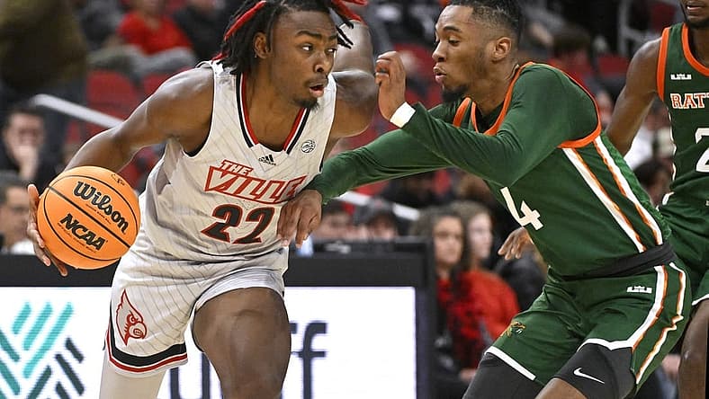 Dec 17, 2022; Louisville, Kentucky, USA; Louisville Cardinals forward Kamari Lands (22) dribbles against Florida A&M Rattlers guard Hantz Louis-Jeune (4) during the first half at KFC Yum! Center. Mandatory Credit: Jamie Rhodes-USA TODAY Sports