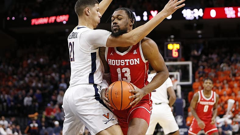 Dec 17, 2022; Charlottesville, Virginia, USA; Houston Cougars forward J'Wan Roberts (13) attempts to shoot the ball as Virginia Cavaliers forward Kadin Shedrick (21) defends during the first half at John Paul Jones Arena. Mandatory Credit: Amber Searls-USA TODAY Sports