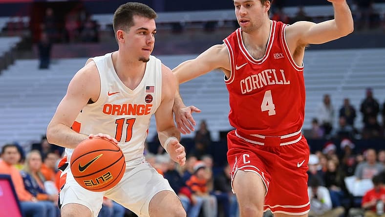 Dec 17, 2022; Syracuse, New York, USA; Syracuse Orange guard Joseph Girard III (11) drives to the basket as Cornell Big Red guard Greg Dolan (4) defends during the first half at the JMA Wireless Dome. Mandatory Credit: Rich Barnes-USA TODAY Sports