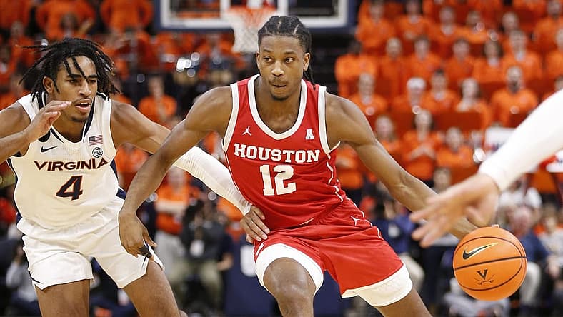 Dec 17, 2022; Charlottesville, Virginia, USA; Houston Cougars guard Tramon Mark (12) dribbles the ball as Virginia Cavaliers guard Armaan Franklin (4) defends during the first half at John Paul Jones Arena. Mandatory Credit: Amber Searls-USA TODAY Sports