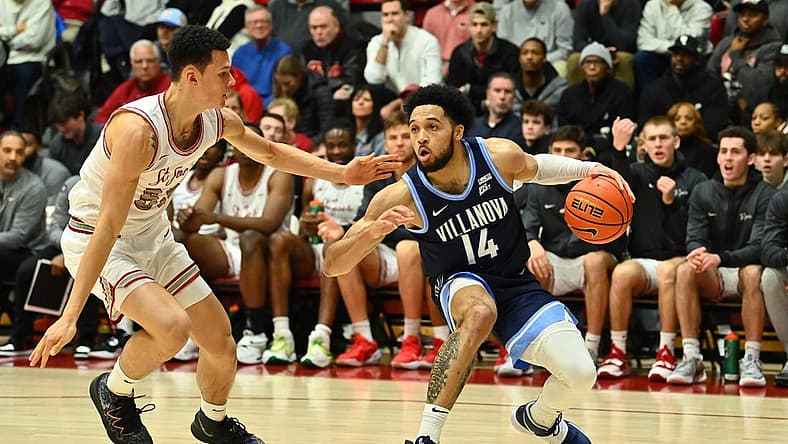 Dec 17, 2022; Philadelphia, Pennsylvania, USA; Villanova Wildcats guard Caleb Daniels (14) shields the ball from Saint Joseph's Hawks forward Louis Bleechmore (55) in the first half at Michael J. Hagan Arena. Mandatory Credit: Kyle Ross-USA TODAY Sports