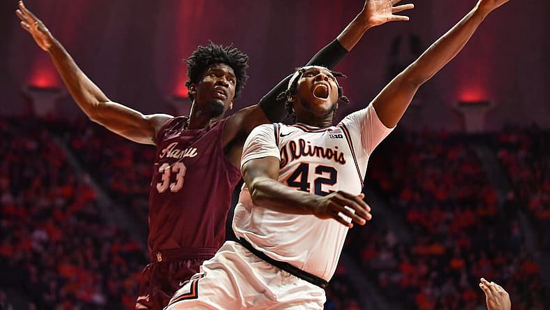 Dec 17, 2022; Champaign, Illinois, USA; Illinois Fighting Illini forward Dain Dainja (42) drives to the basket as Alabama A&M Bulldogs center Olisa Blaise Akonobi (33) defends during the first half at State Farm Center. Mandatory Credit: Ron Johnson-USA TODAY Sports