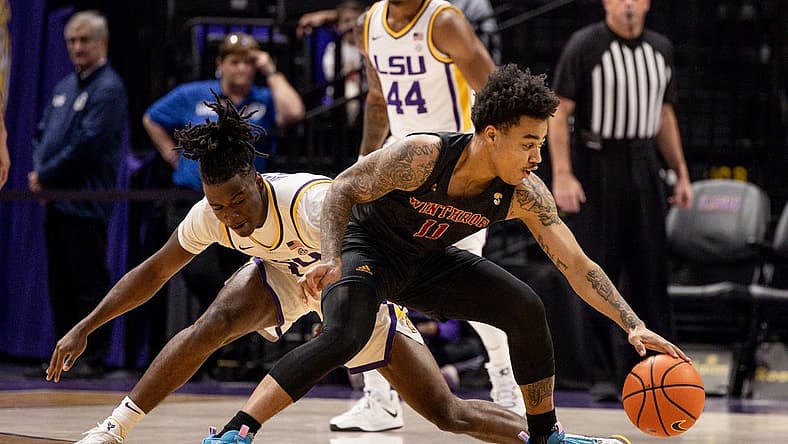 Dec 17, 2022; Baton Rouge, Louisiana, USA; Winthrop Eagles guard Kasen Harrison (11) dribbles against LSU Tigers guard Cam Hayes (1) during the first half at Pete Maravich Assembly Center. Mandatory Credit: Stephen Lew-USA TODAY Sports
