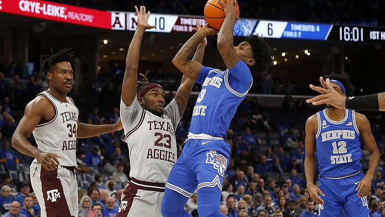 Dec 17, 2022; Memphis, Tennessee, USA; Memphis Tigers guard Kendric Davis (3) shoots as Texas A&M Aggies guard Tyrece Radford (23) defends during the first half at FedExForum. Mandatory Credit: Petre Thomas-USA TODAY Sports
