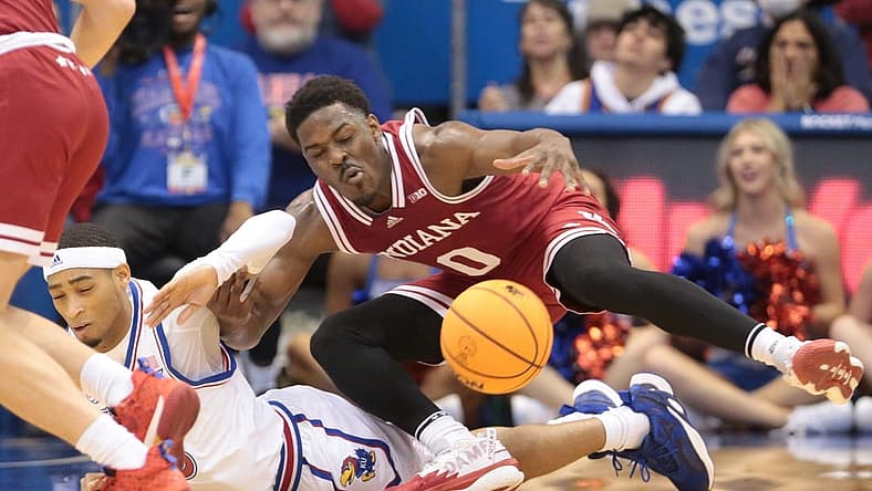 Indiana super-senior Xavier Johnson (0) trips on Kansas redshirt junior guard Dajuan Harris Jr. (3) during the first half of Saturday's game inside Allen Fieldhouse.
Syndication The Topeka Capital Journal