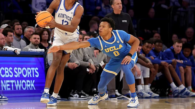 Dec 17, 2022; New York, New York, USA; Kentucky Wildcats guard Antonio Reeves (12) controls the ball against UCLA Bruins guard Jaylen Clark (0) during the second half at Madison Square Garden. Mandatory Credit: Brad Penner-USA TODAY Sports