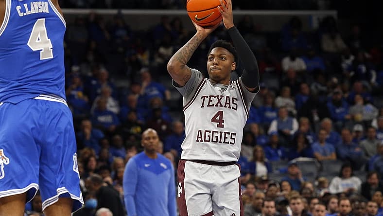 Dec 17, 2022; Memphis, Tennessee, USA; Texas A&M Aggies guard Wade Taylor IV (4) shoots for three during the second half against the Memphis Tigers at FedExForum. Mandatory Credit: Petre Thomas-USA TODAY Sports