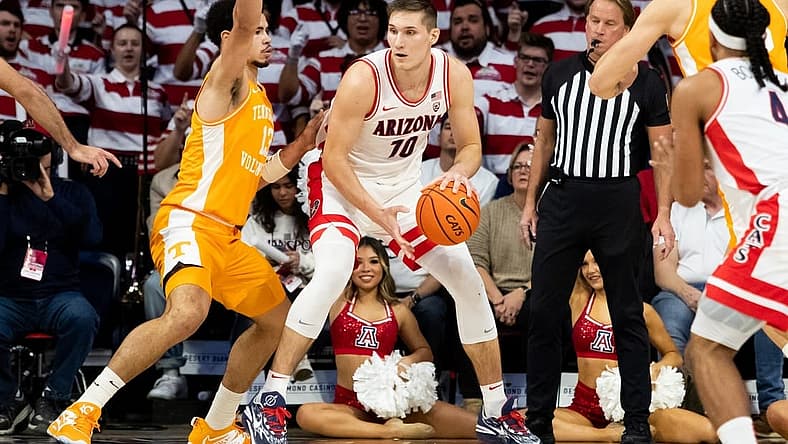 Dec 17, 2022; Tucson, Arizona, USA; Arizona Wildcats forward Azuolas Tubelis (10) drives to the net against Tennessee Volunteers forward Olivier Nkamhoua (13) during the first half at McKale Center. Mandatory Credit: Zachary BonDurant-USA TODAY Sports