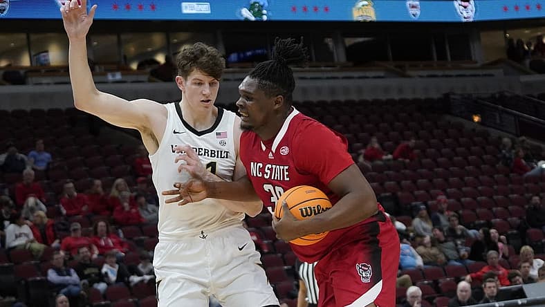 Dec 17, 2022; Chicago, Illinois, USA; Vanderbilt Commodores forward Liam Robbins (21) defends North Carolina State Wolfpack forward D.J. Burns Jr. (30) during the first half at United Center. Mandatory Credit: David Banks-USA TODAY Sports