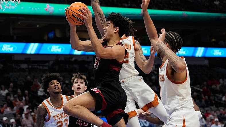 Dec 18, 2022; Dallas, Texas, USA; Stanford Cardinal forward Spencer Jones (14) scores a basket past Texas Longhorns forward Christian Bishop (32) during the first half at American Airlines Center. Mandatory Credit: Chris Jones-USA TODAY Sports