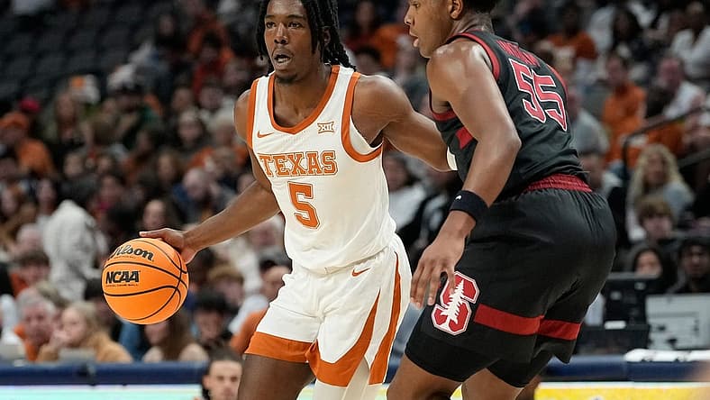 Dec 18, 2022; Dallas, Texas, USA; Texas Longhorns guard Marcus Carr (5) controls the ball against Stanford Cardinal forward Harrison Ingram (55) during the first half at American Airlines Center. Mandatory Credit: Chris Jones-USA TODAY Sports