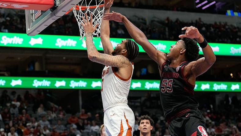 Dec 18, 2022; Dallas, Texas, USA;  Texas Longhorns forward Timmy Allen (0) makes a layup past Stanford Cardinal forward Harrison Ingram (55) during the second half at American Airlines Center. Mandatory Credit: Chris Jones-USA TODAY Sports