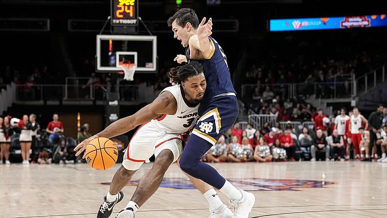 Dec 21, 2022; Athens, Georgia, USA; Georgia Bulldogs guard Kario Oquendo (3) dribbles against Notre Dame Fighting Irish guard Cormac Ryan (5) during the first half at State Farm Arena. Mandatory Credit: Dale Zanine-USA TODAY Sports