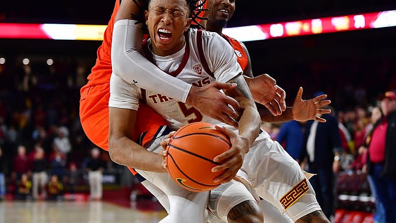 Dec 18, 2022; Los Angeles, California, USA; Southern California Trojans guard Boogie Ellis (5) is fouled by Auburn Tigers forward Johni Broome (4) during the second half at Galen Center. Mandatory Credit: Gary A. Vasquez-USA TODAY Sports
