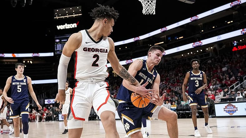Dec 21, 2022; Athens, Georgia, USA; Georgia Bulldogs forward KyeRon Lindsay (2) and Notre Dame Fighting Irish forward Nate Laszewski (14) battle for the ball during the first half at State Farm Arena. Mandatory Credit: Dale Zanine-USA TODAY Sports