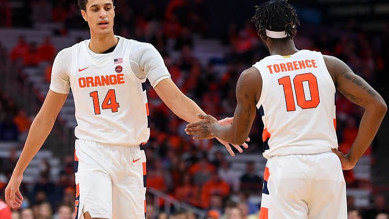 Dec 17, 2022; Syracuse, New York, USA; Syracuse Orange center Jesse Edwards (14) and guard Symir Torrence (10) reacts to a play against the Cornell Big Red during the second half at the JMA Wireless Dome. Mandatory Credit: Rich Barnes-USA TODAY Sports