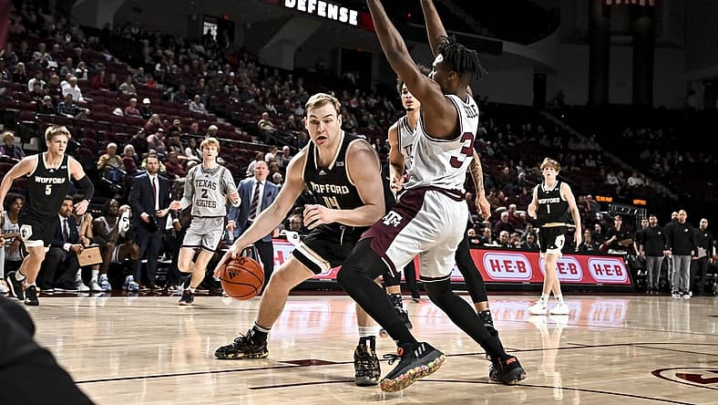 Dec 20, 2022; College Station, Texas, USA; Wofford Terriers center Kyler Filewich (14) drives as Texas A&M Aggies forward Julius Marble (34) defends during the first half at Reed Arena. Mandatory Credit: Maria Lysaker-USA TODAY Sports