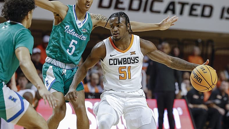 Dec 20, 2022; Stillwater, Oklahoma, USA; Oklahoma State Cowboys guard John-Michael Wright (51) is defended by Texas A&M-Corpus Christi Islanders guard Jourdyn Grandberry (5) during the first half at Gallagher-Iba Arena. Mandatory Credit: Alonzo Adams-USA TODAY Sports