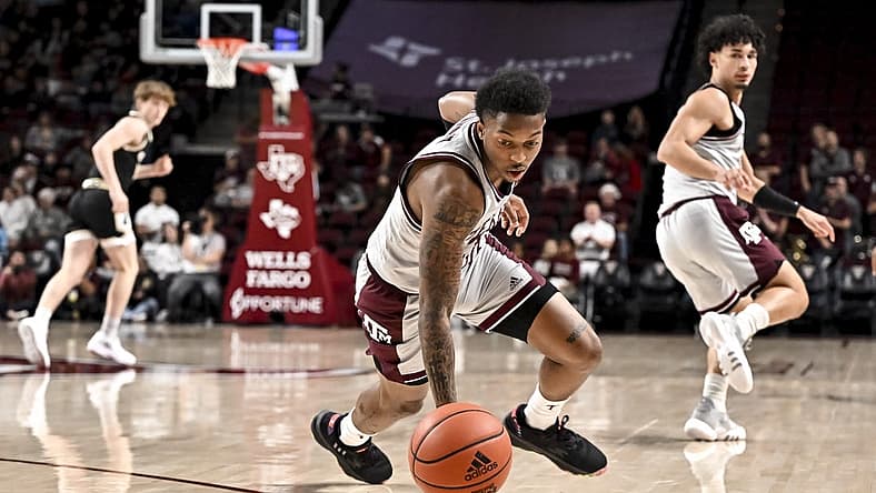 Dec 20, 2022; College Station, Texas, USA; Texas A&M Aggies guard Wade Taylor IV (4) lunges for a loose ball during the first half against the Wofford Terriers at Reed Arena. Mandatory Credit: Maria Lysaker-USA TODAY Sports