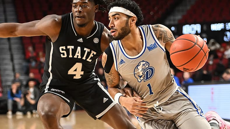 Dec 20, 2022; Lincoln, Nebraska, USA; Drake Bulldogs guard Roman Penn (1) drives against Mississippi State Bulldogs guard Cameron Matthews (4) in the first half at Pinnacle Bank Arena. Mandatory Credit: Steven Branscombe-USA TODAY Sports