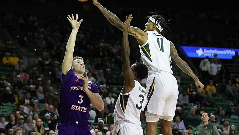 Dec 20, 2022; Waco, Texas, USA; Baylor Bears forward Jalen Bridges (11) blocks the shot of Northwestern State Demons guard Isaac Haney (3) during the first half at Ferrell Center. Mandatory Credit: Raymond Carlin III-USA TODAY Sports