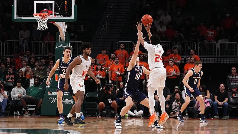 Dec 20, 2022; Coral Gables, Florida, USA; Miami Hurricanes guard Nijel Pack (24) attempts a three point shot over Virginia Cavaliers guard Taine Murray (10) during the first half at Watsco Center. Mandatory Credit: Jasen Vinlove-USA TODAY Sports