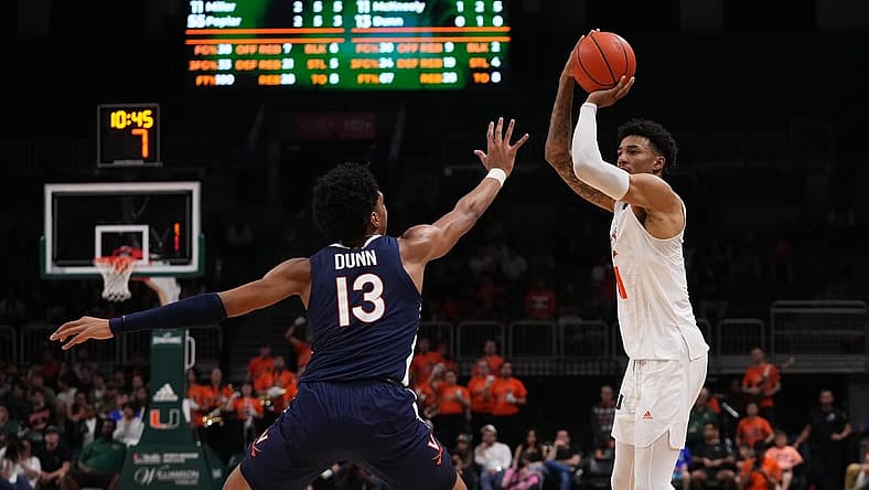 Dec 20, 2022; Coral Gables, Florida, USA; Miami Hurricanes guard Jordan Miller (11) shoots over Virginia Cavaliers guard Ryan Dunn (13) during the second half at Watsco Center. Mandatory Credit: Jasen Vinlove-USA TODAY Sports